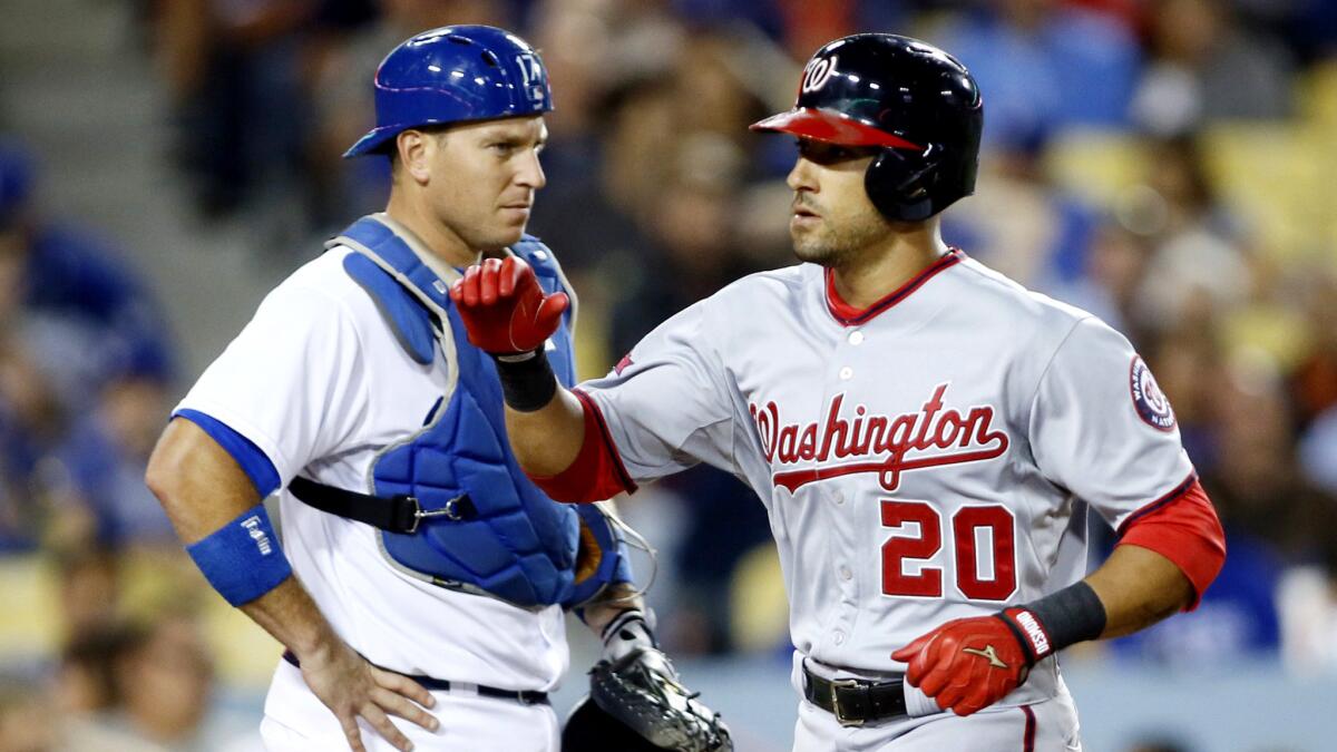 Nationals shortstop Ian Desmond (20) crosses the plate in front of Dodgers catcher A.J. Ellis after hitting a solo home run in the eighth inning Monday night at Dodger Stadium.