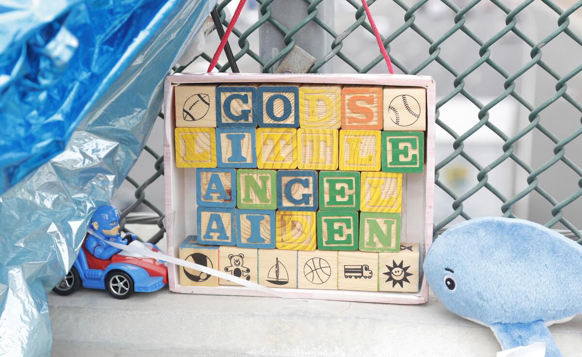 Toy blocks spell out a message at the memorial shrine for Aiden Leos.