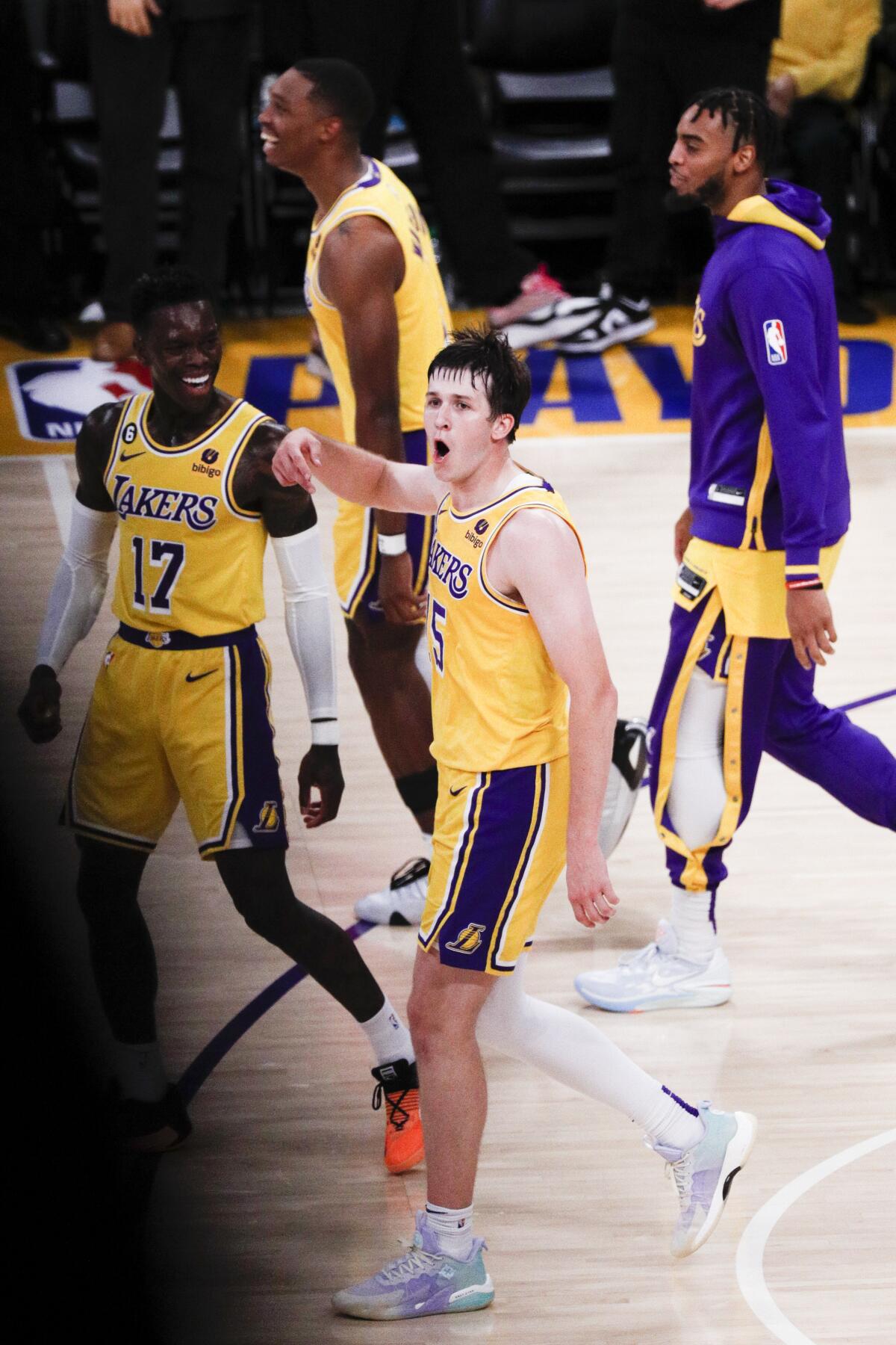 Lakers guard Austin Reaves reacts after making a buzzer-beating half-court shot.