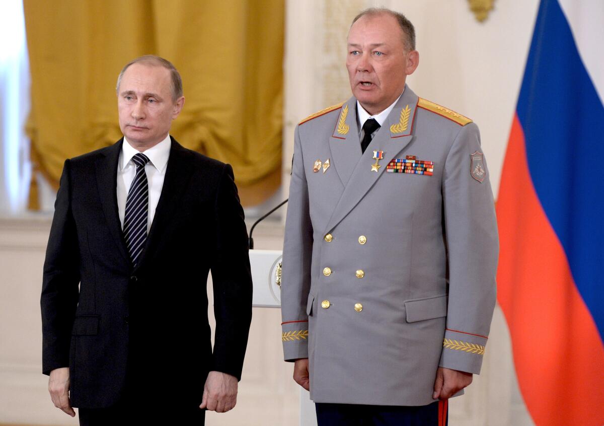 Russian President Vladimir Putin, left, poses with Col. Gen. Alexander Dvornikov during an award ceremony at the Kremlin 