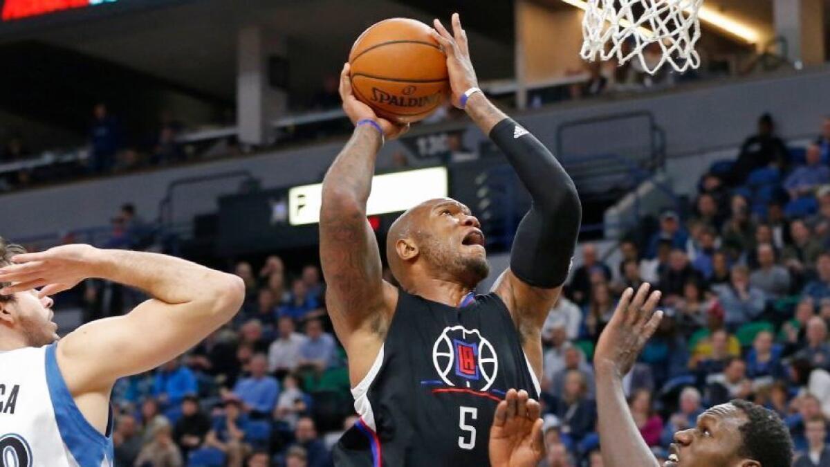 Clippers forward Marreese Speights (5) eyes the basket as Minnesota Timberwolves' Nemanja Bjelica (88) and Gorgui Dieng defend during the second half on Mar. 8.