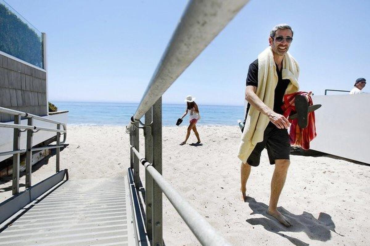 Laurent Puechguirbal leaves Carbon Beach in Malibu via a public access path. This stretch of sand is also called Billionaires Beach, where visitors might catch a glimpse of bigwigs such as Eli Broad, Haim Saban and Jeffrey Katzenberg.