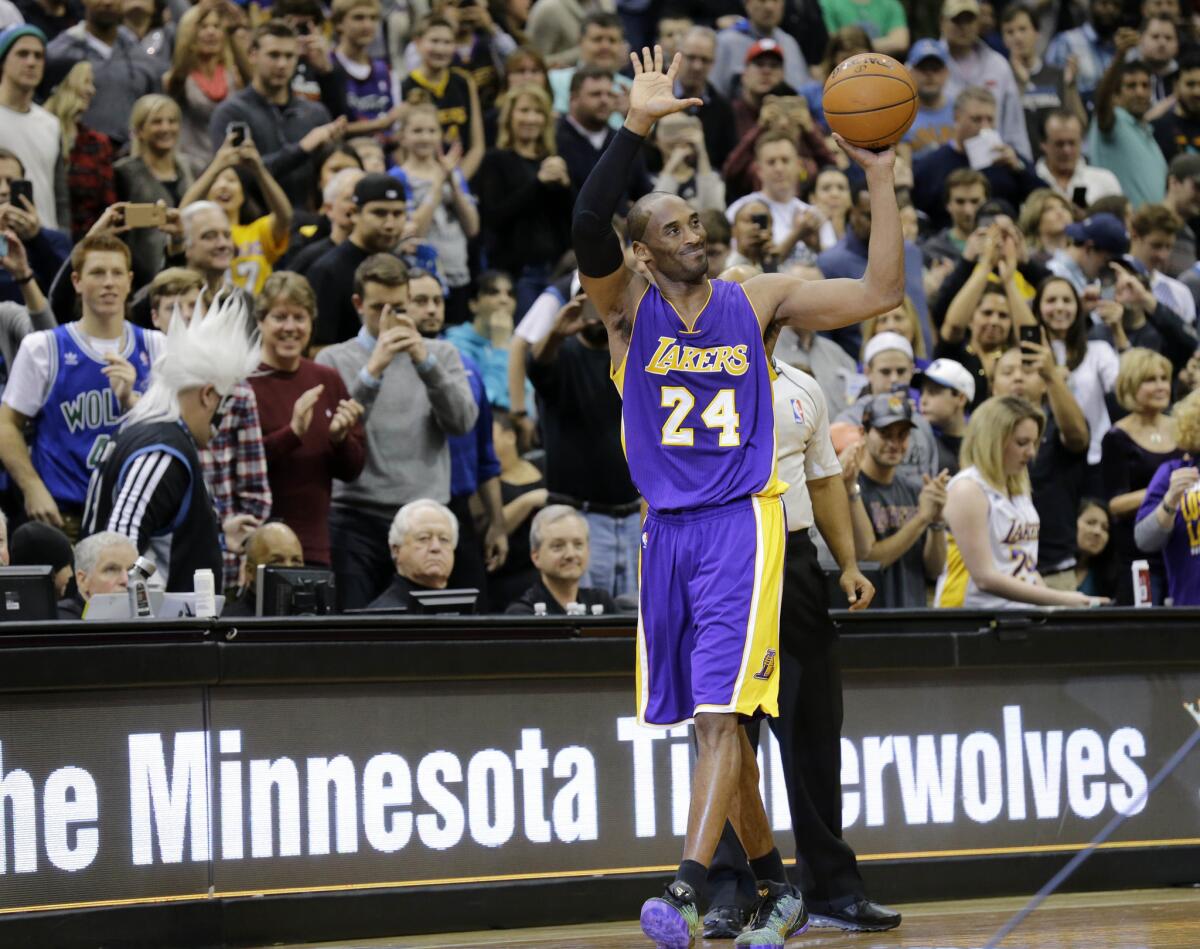 Lakers guard Kobe Bryant holds up the ball and waves to the Minnesota crowd after passing Michael Jordan for third on the NBA all-time scoring list.