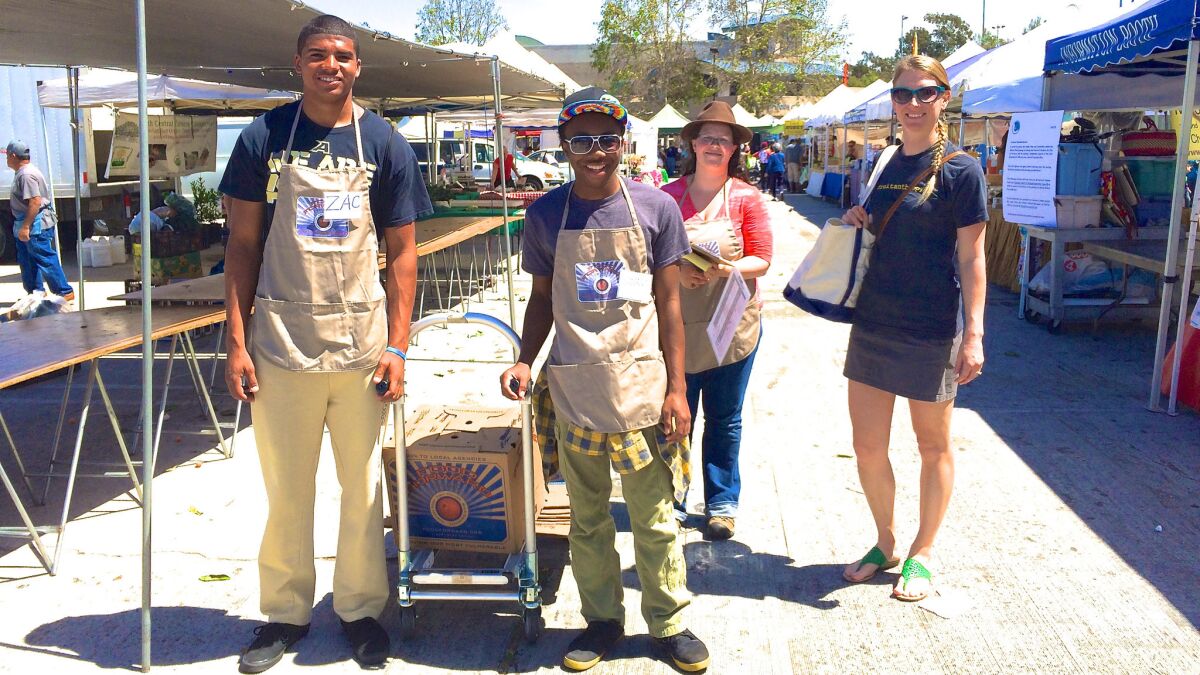 Food Forward volunteers Zachery McGraw and Sonari Chidi, "glean team" leader Claire Moss and farmers market program manager Leah Boyer.
