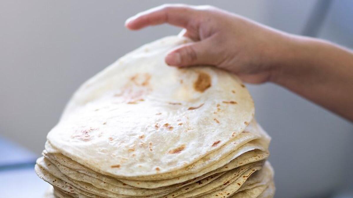 Sonoratown tortillera Julia Guerrero stacks freshly pressed tortillas