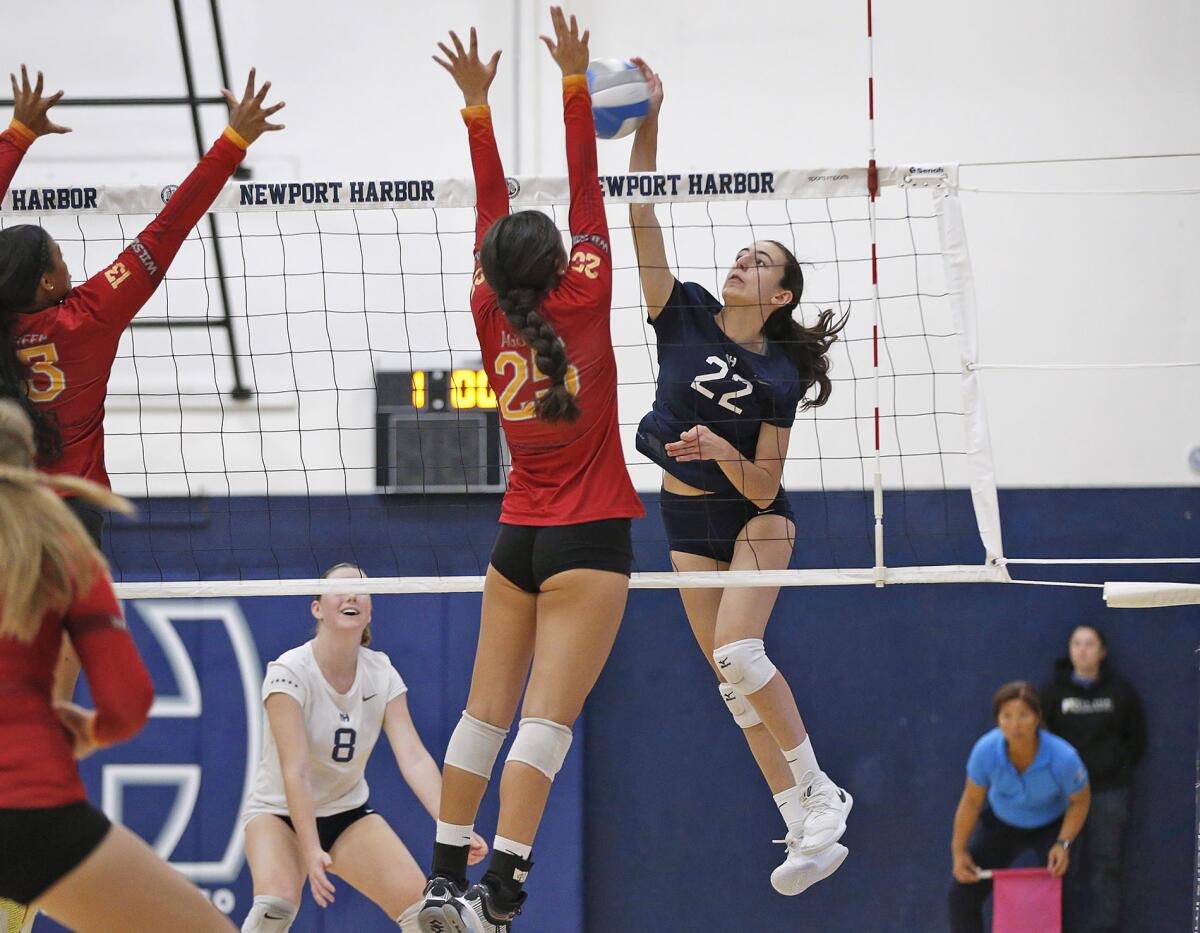 Newport Harbor's Vladimira Kotzakov (22) hits a shot from the outside past Long Beach Wilson's Peyton Agura on Wednesday.