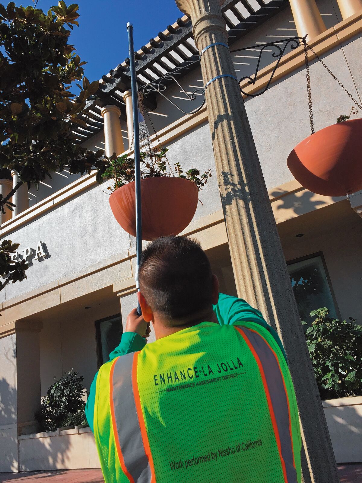Ciro Rodriguez, representing Enhance La Jolla, waters some previously neglected planters on Herschel Avenue in the Village of La Jolla, October 2019.
