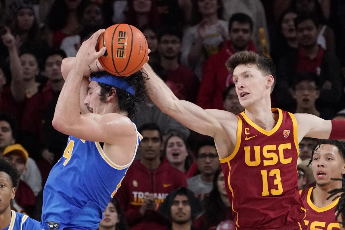 USC guard Drew Peterson, right, blocks a shot by UCLA guard Jaime Jaquez Jr. during the second half.