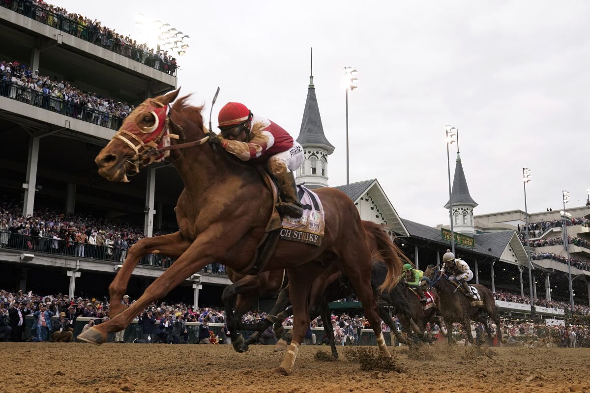 Rich Strike, with jockey Sonny Leon aboard, wins the 148th running of the Kentucky Derby at Churchill Downs on Saturday.