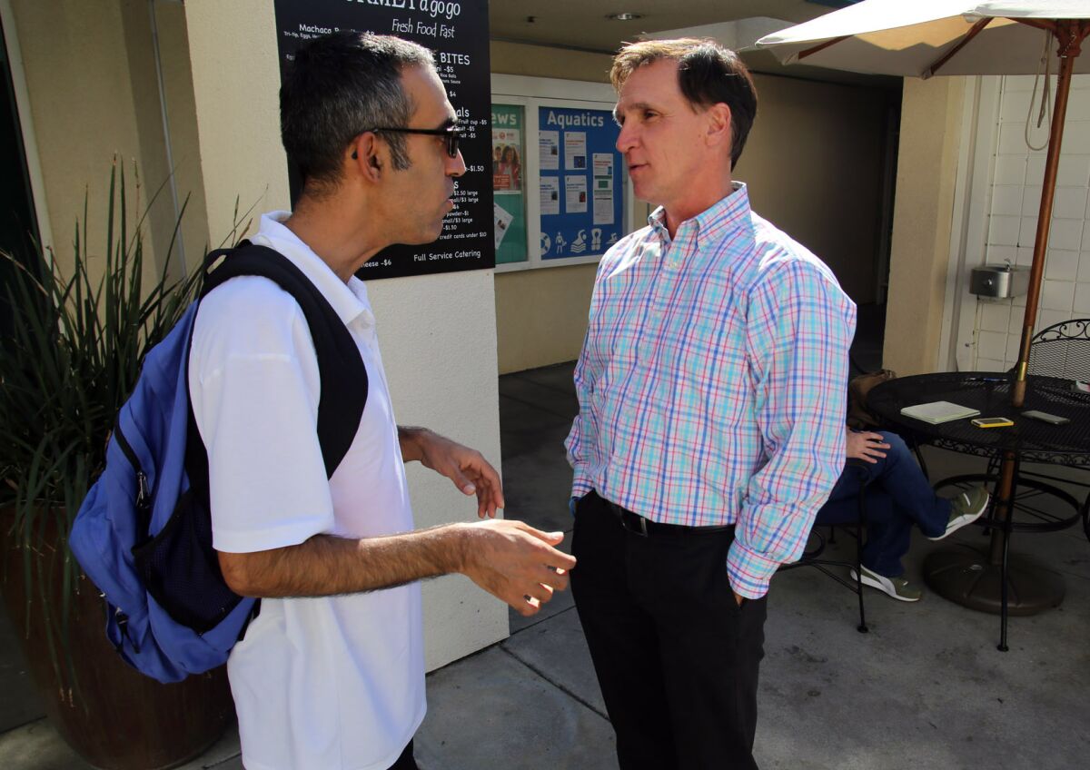 Tyler Wright talks with a friend at the Crescenta-Cañada Y in La Cañada. Wright is leaving his post at the YMCA of the Foothills after nearly 10 years as chief executive and president.