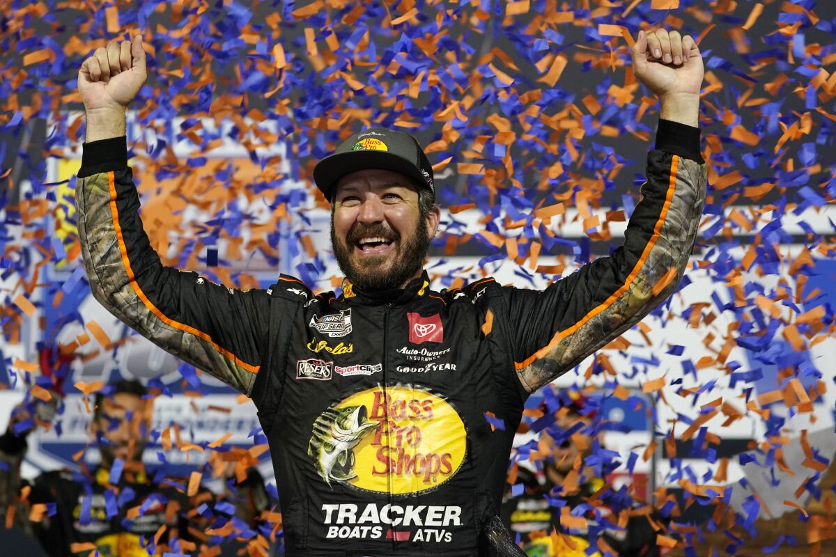 FILE - In this Sept. 11, 2021, file photo, Martin Truex Jr., celebrates winning the NASCAR Cup series auto race in Richmond, Va. Truex is in third place in the NASCAR playoff standings heading into Sunday's race at Fort Worth, Texas. (AP Photo/Steve Helber, File)