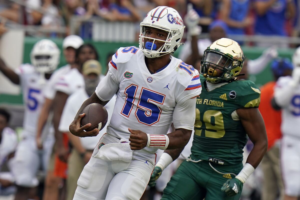 Florida quarterback Anthony Richardson (15) gets past South Florida linebacker Brian Norris (29) on an 80-yard touchdown run during the second half of an NCAA college football game Saturday, Sept. 11, 2021, in Tampa, Fla. (AP Photo/Chris O'Meara)