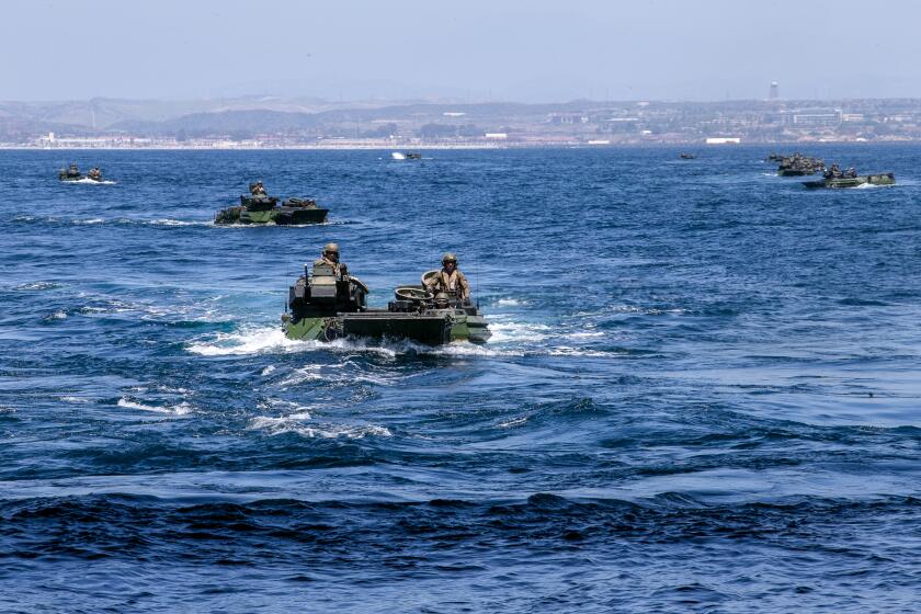 U.S. Marines operate AAV-P7/A1 assault amphibious vehicles into the well deck of the amphibious landing dock USS Somerset.