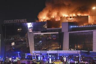 Smoke rises above the Crocus City Hall concert venue following a reported shooting incident, near Moscow, Russia. 