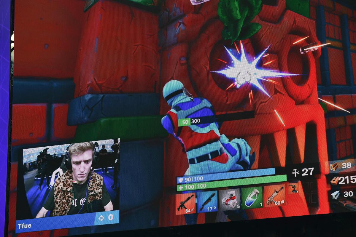 Streamer Tfue in a small screen at the bottom of screen showing a Fortnite battle