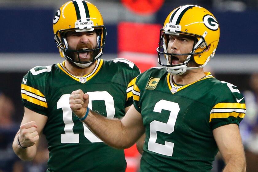 Packers kicker Mason Crosby (2) celebrates his 56-yard field goal against the Cowboys with holder Jacob Schum (10) during the fourth quarter Sunday.