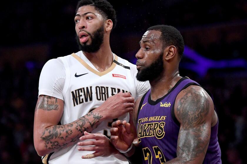 LOS ANGELES, CALIFORNIA - DECEMBER 21: LeBron James #23 of the Los Angeles Lakers guards Anthony Davis #23 of the New Orleans Pelicans during a 112-104 Laker win at Staples Center on December 21, 2018 in Los Angeles, California. NOTE TO USER: User expressly acknowledges and agrees that, by downloading and or using this photograph, User is consenting to the terms and conditions of the Getty Images License Agreement. (Photo by Harry How/Getty Images) ** OUTS - ELSENT, FPG, CM - OUTS * NM, PH, VA if sourced by CT, LA or MoD **
