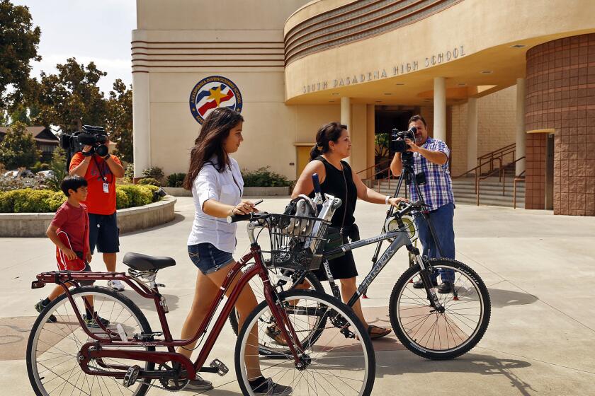 Isabella Gonzalez, 14, left with her mother, Lourdes Mosqueda, right, arrive at South Pasadena High School on Tuesday for final preparations before Isabella starts school as a freshman. Gov. Jerry Brown does not want a school bond on the same ballot with a water bond and Rainy Day Fund proposition, a lawmaker said.