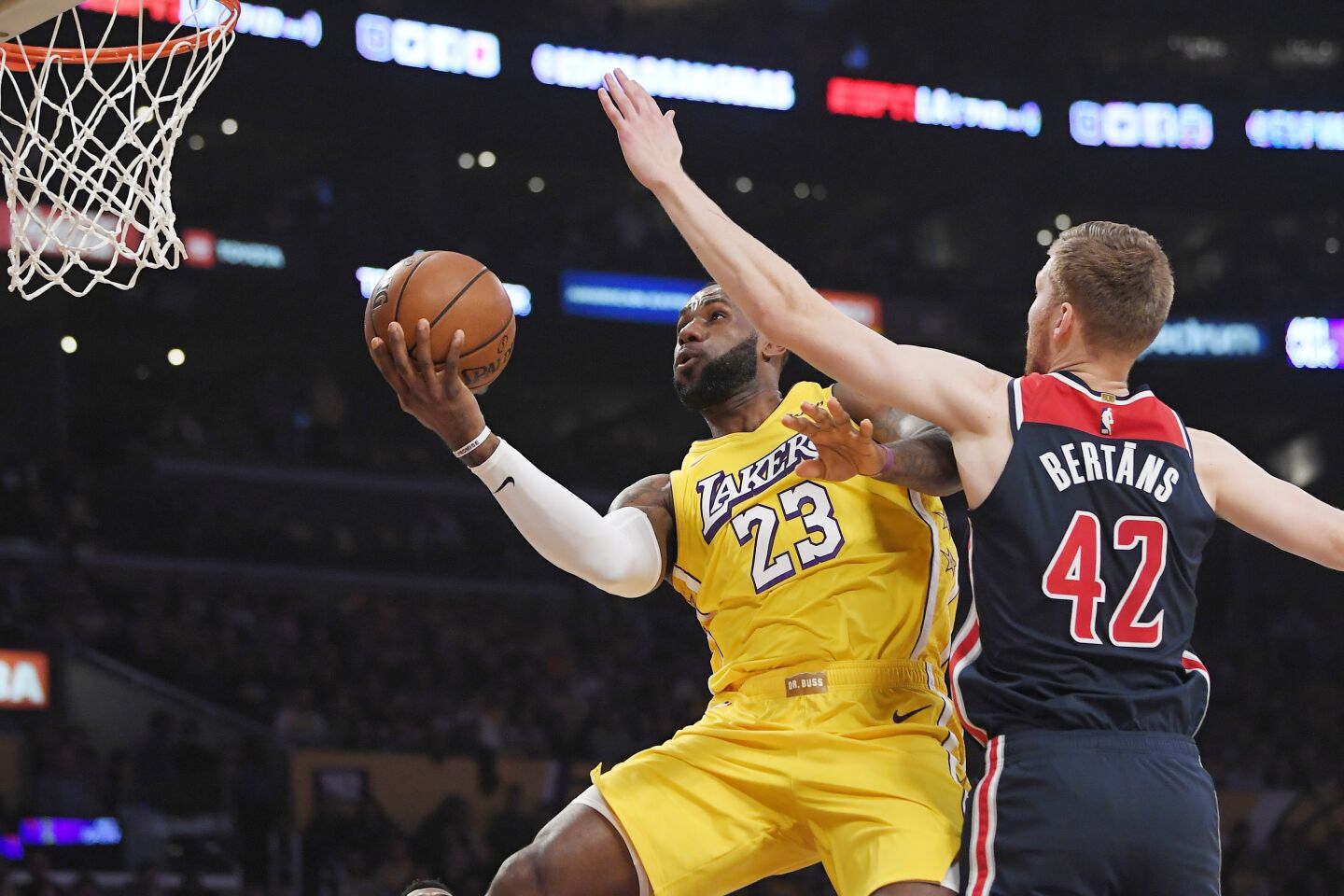 Lakers forward LeBron James goes up to the basket against Wizards forward Davis Bertans during the first half of a game Nov. 29 at Staples Center.