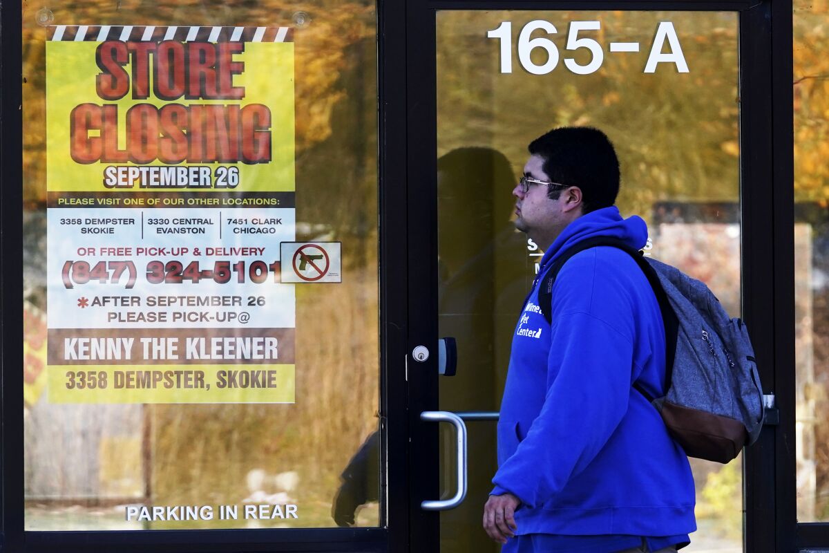 A man walks past a closed store in Wilmette, Ill., amid the coronavirus pandemic. 