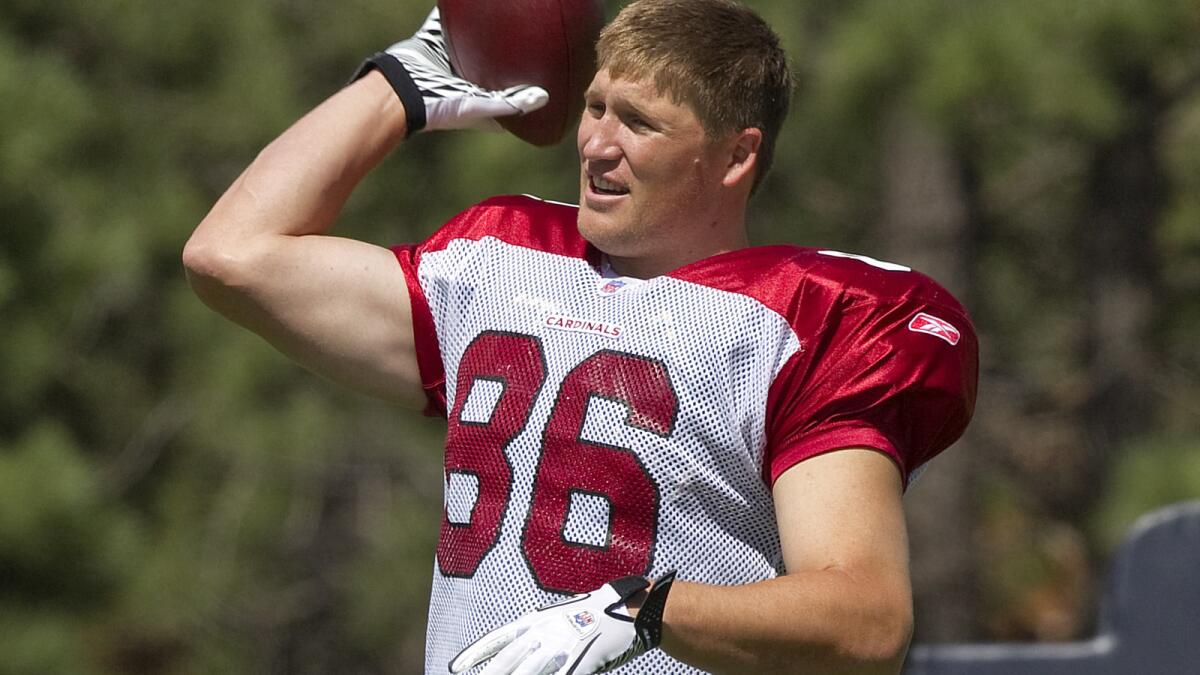 Then with the Arizona Cardinals, Todd Heap warms up at NFL football training camp in Flagstaff, Ariz., in 2011.