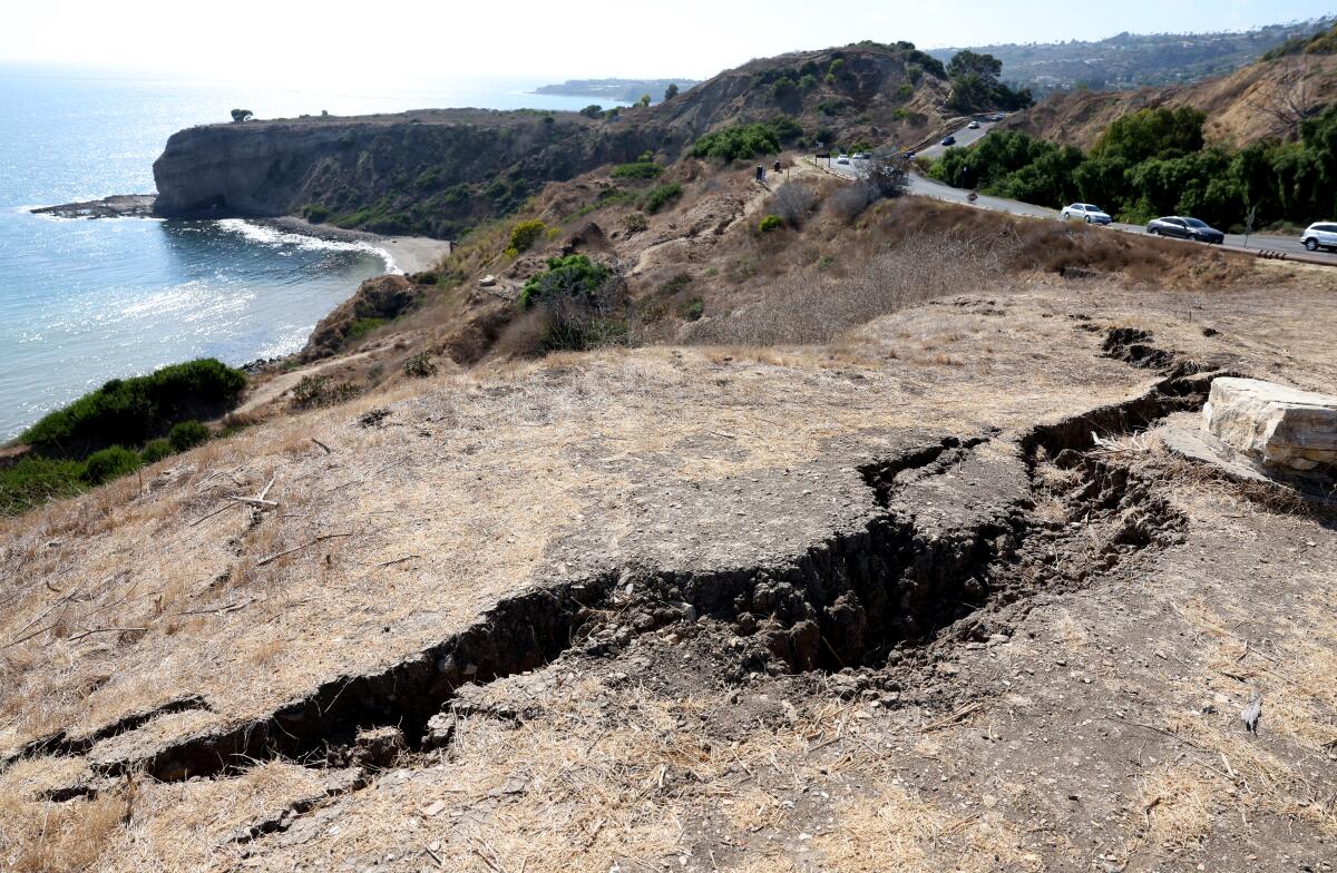 A huge crack forms along Palos Verdes Drive South in Rancho Palos Verdes where a landslide has accelerated.