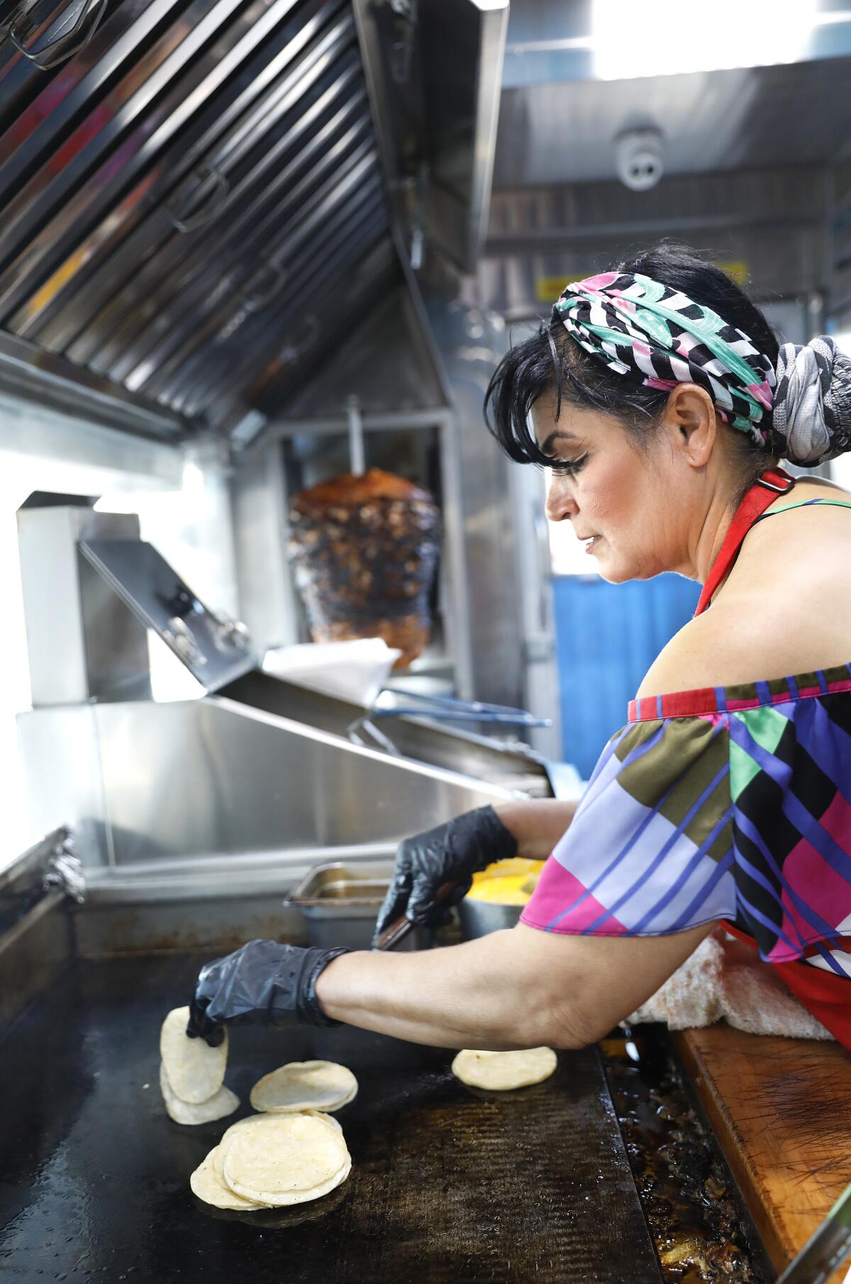 Maria Cárdenas cooks on the Tacos La Madrina truck parked in Hesperia.