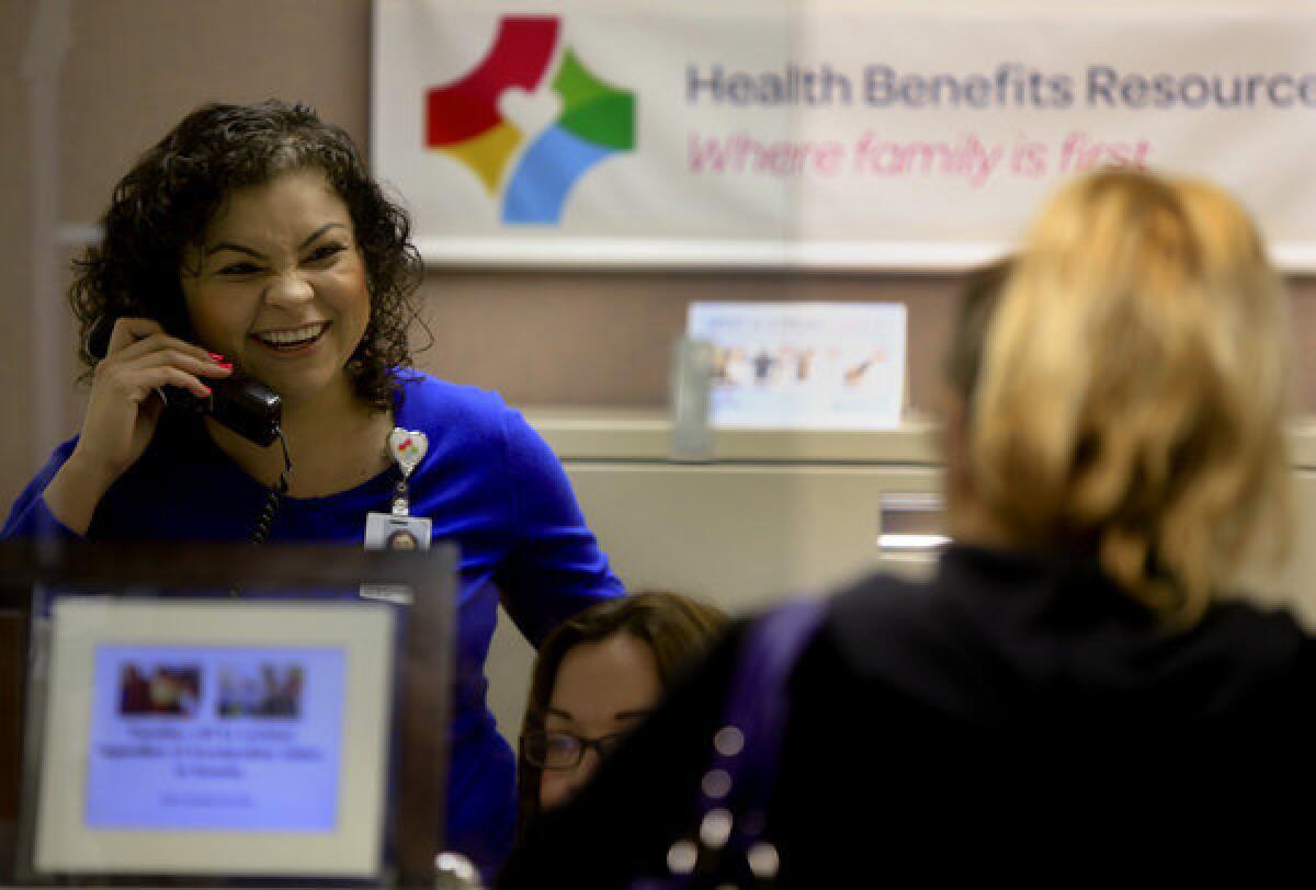 Rosana Herrera, left, operations coordinator at the Health Benefits Resource Center at St. Francis Medical Center in Lynwood, offers daily help and counsel on the Affordable Care Act and insurance exchange issues to confused patients and clients.