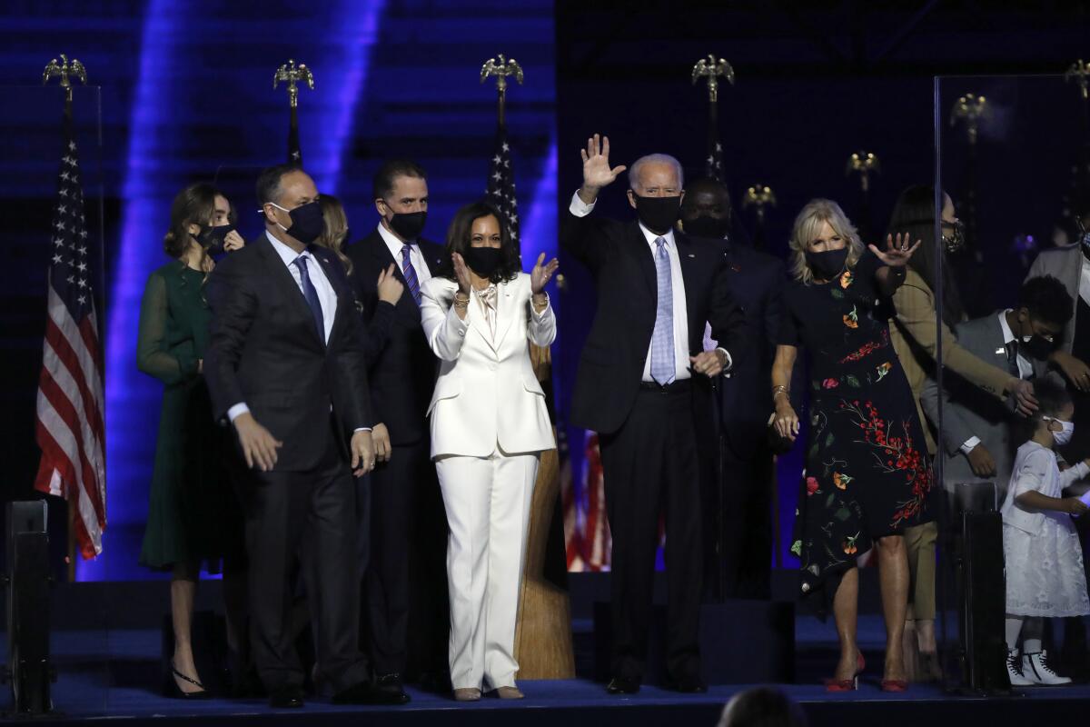 Douglas Emhoff, Vice-President-elect Kamal Harris, President-elect Joe Biden and Dr. Jill Biden wave to supporters.