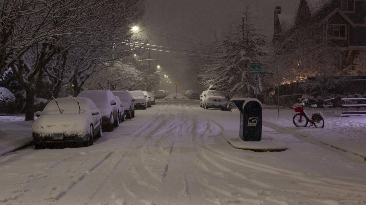 In Seattle, officials urged people to stay off the roads as traffic slowed to a standstill in some places because of the snow.