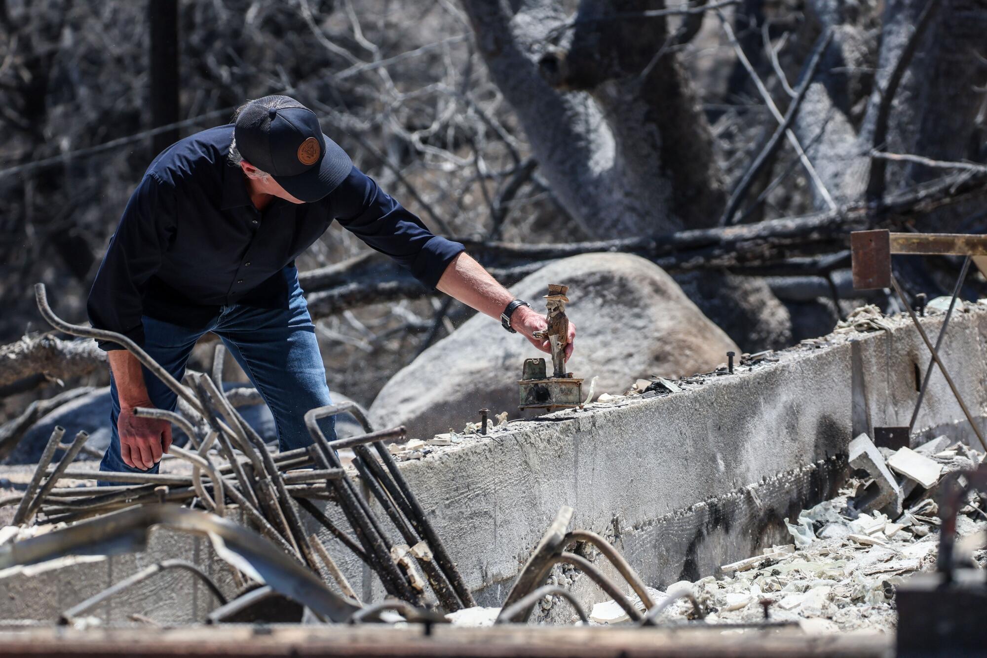 Gavin Newsom holds a coin bank found in museum rubble.