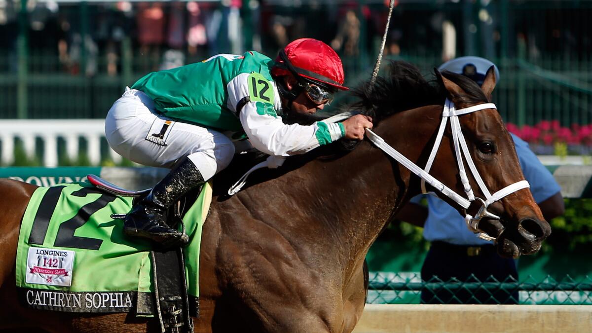 Jockey Javier Castellano guides Cathryn Sophia to the finish line to win the Kentucky Oaks on Friday at Churchill Downs.