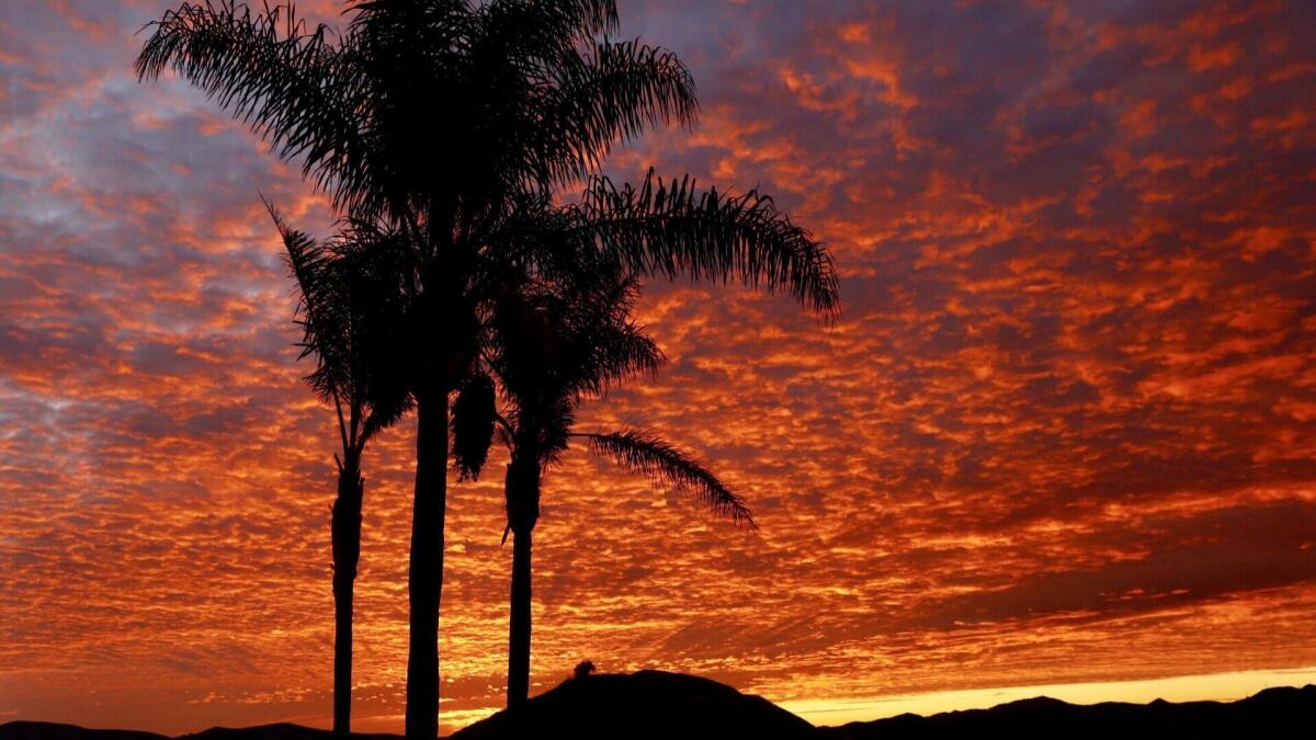 A sunrise Monday morning turns the sky red above Thousand Oaks as the region braces for more rain this week.