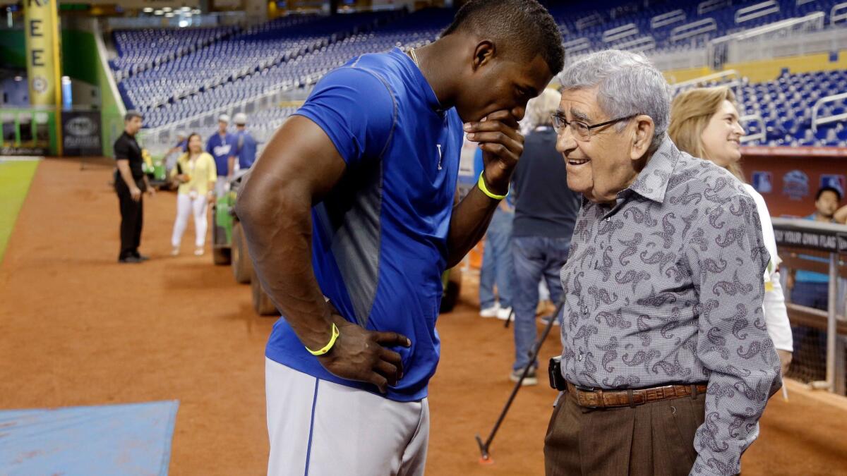 Los Angeles Dodgers right fielder Yasiel Puig, left, talks with Spanish language broadcaster Rafael "Felo" Ramirez on Aug. 21, 2013,