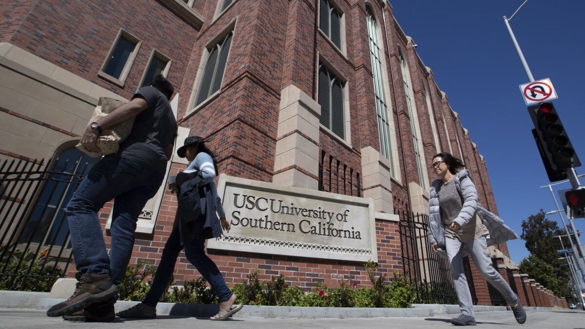 USC officials have placed holds on the accounts of students possibly tied to a far-reaching scandal in which wealthy parents allegedly paid hefty sums to secure admission to schools across the country through bribes and lies.