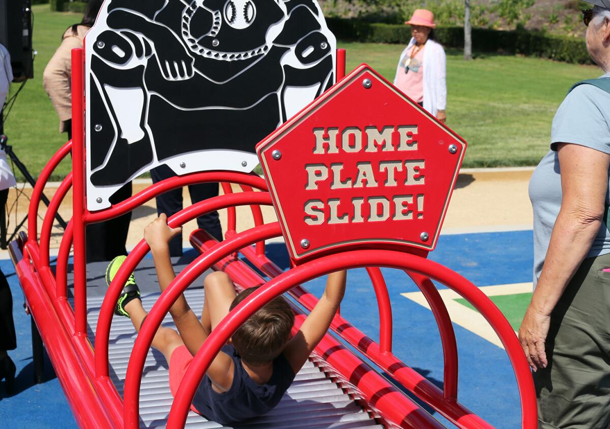 Children play on the Home Plate Slide at Fountain Valley Sports Park.