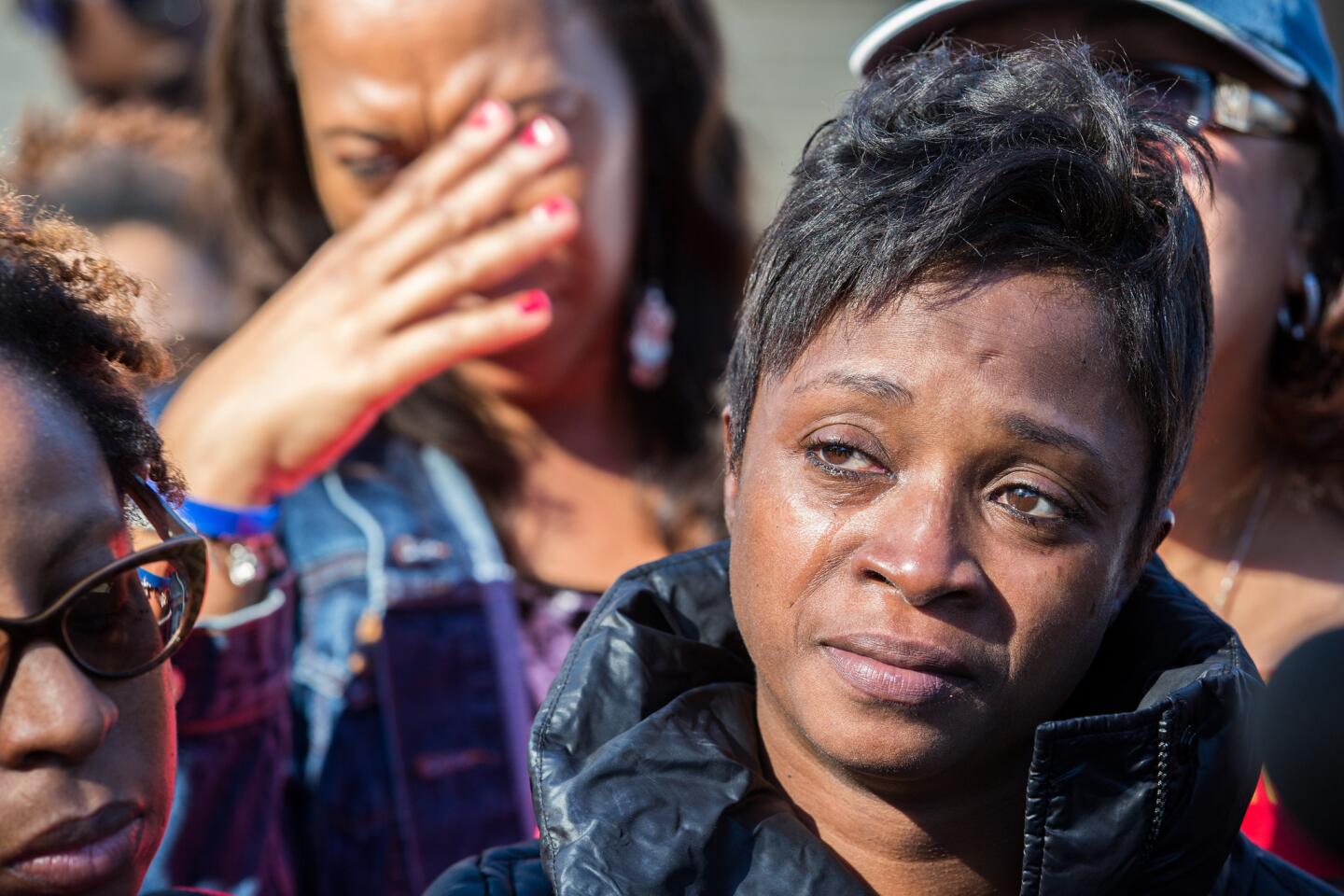 Tanesha Reed, the mother of slain Demarius Reed gets emotional on Nov. 3, 2015, as the Rev. Michael Pfleger talks at the site where Tyshawn Lee, 9, was fatally shot in Gresham neighborhood the day before. Demarius Reed, 21, was found shot to death on Oct. 18, 2013.