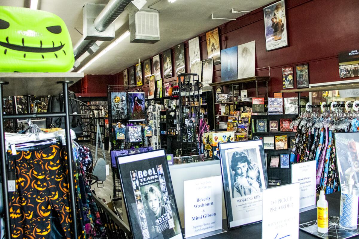 Items hanging on racks and sitting on shelves for sale inside Dark Delicacies