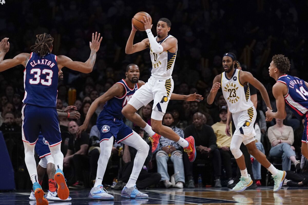 Indiana Pacers' Tyrese Haliburton, top center, looks to pass during the second half of an NBA basketball game against the Brooklyn Nets at the Barclays Center, Sunday, Apr. 10, 2022, in New York. The Nets defeated the Pacers 134-126. (AP Photo/Seth Wenig)