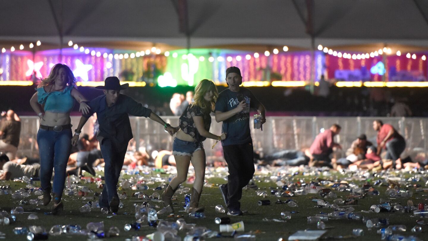 People run from the Route 91 Harvest country music festival after the event was targeted by a gunman shooting from a nearby hotel.