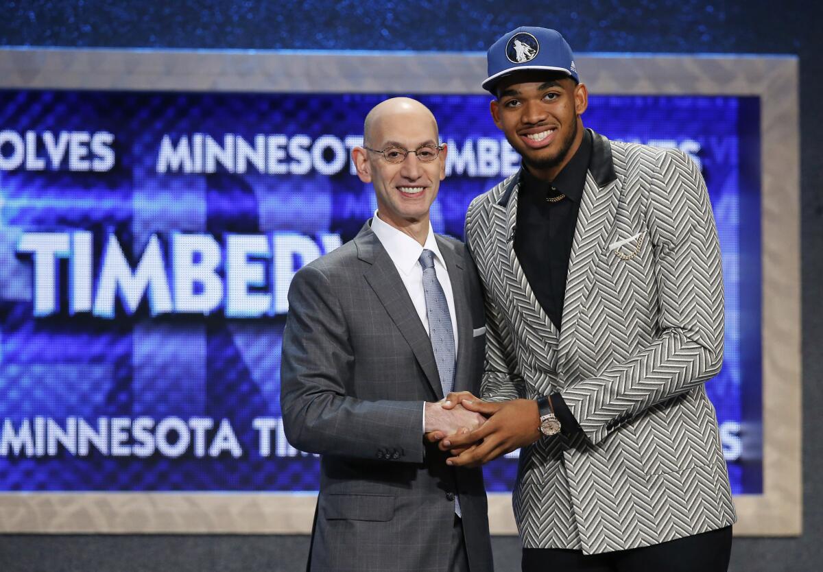 Kentucky power forward Karl-Anthony Towns smiles with NBA Commisioner Adam Silver after being selected with the No. 1 overall pick by the Minnesota Timberwolves.