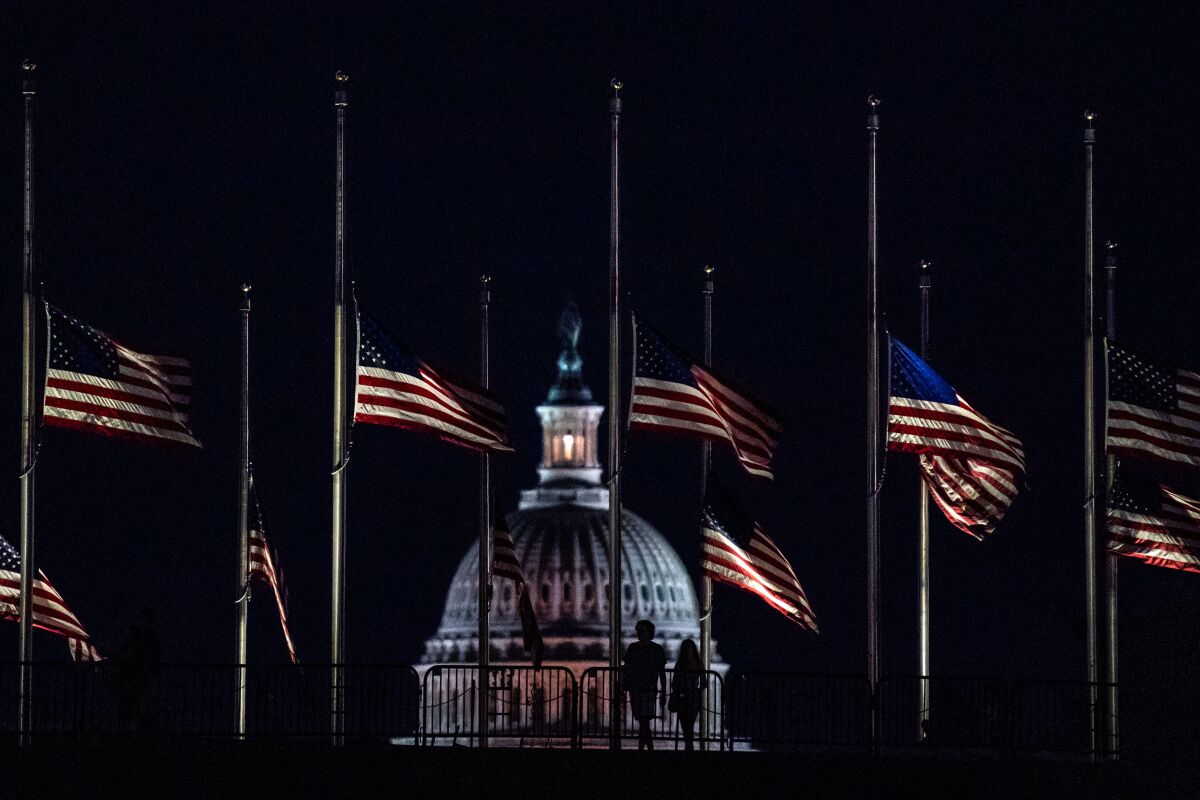 Flags flying at half staff in Washington at nighttime