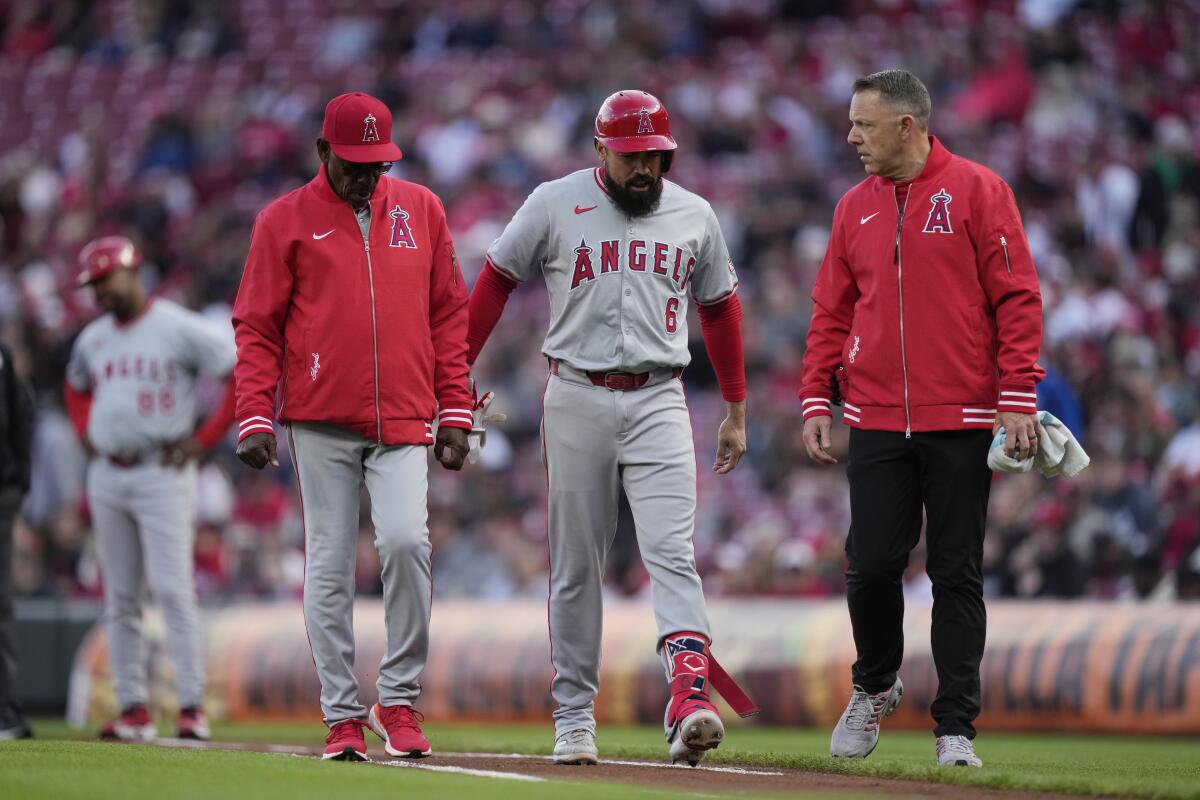 Angels third baseman Anthony Rendon walks off the field with manager Ron Washington.