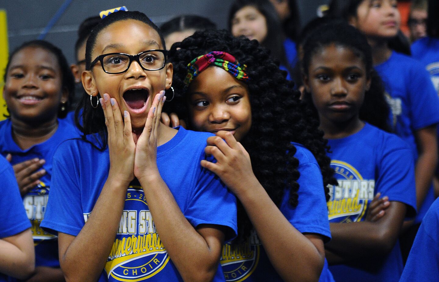 Young pregame performers react as Kobe Bryant approaches before a game with the Rockets in Houston.