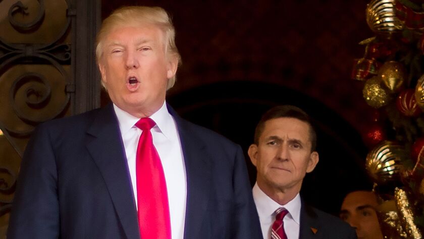US President-elect Donald Trump with his National Security Adviser designate Lt. General Michael Flynn (R) on Dec. 21, 2016 at Mar-a-Lago in Palm Beach, Fla. Flynn resigned the position Feb. 13 during concerns over his contacts with Russia.