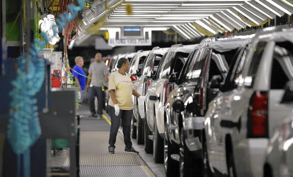 General Motors dealers delivered 284,694 vehicles in May, up 12.6% from a year earlier. Above, a worker inspects SUVs coming off the assembly line last month at the GM plant in Arlington, Texas.