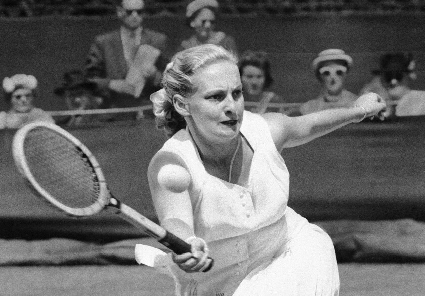FILE - Darlene Hard hits a forehand to Zsuzsa Kormoczy during a quarterfinal on June 28, 1955 at Wimbledon tennis championships in London. Hard, an aggressive serve-and-volley player who won three major singles titles as well as 18 major doubles titles in a Hall of Fame tennis career, died Thursday, Dec. 2, 2021, after a brief illness. She was 85. (AP Photo, File)