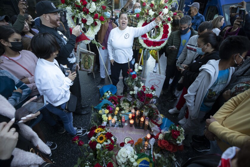 Fans gather around Vicente Fernández's star on Hollywood Boulevard singing his songs during a makeshift memorial.