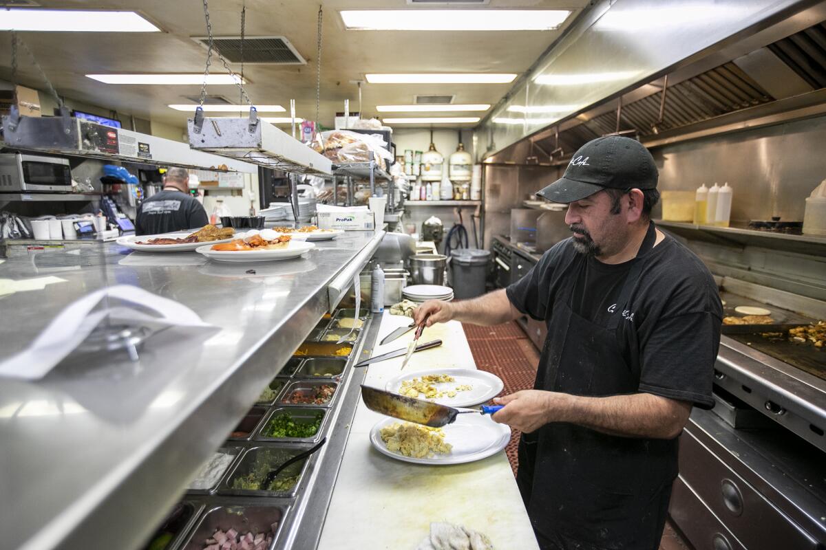 George Esparza, an employee of Cappy's Cafe for 27 years, prepares breakfast.