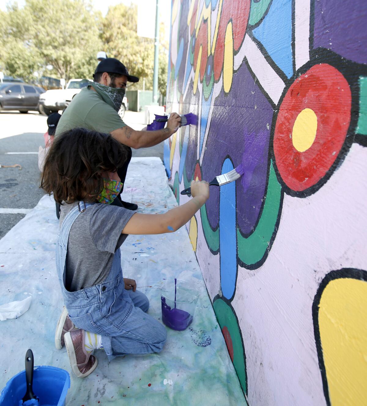 Muralist Josh Madrid and 5-year old daughter Dali retouch artwork at Costa Mesa's Skatepark on Oct. 3, 2020.